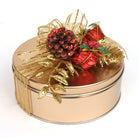 Decorative round gold tin with red and gold ornaments on a white background