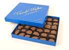 Open blue box of VandeWalle Candies  pecan turtles shown on a white background