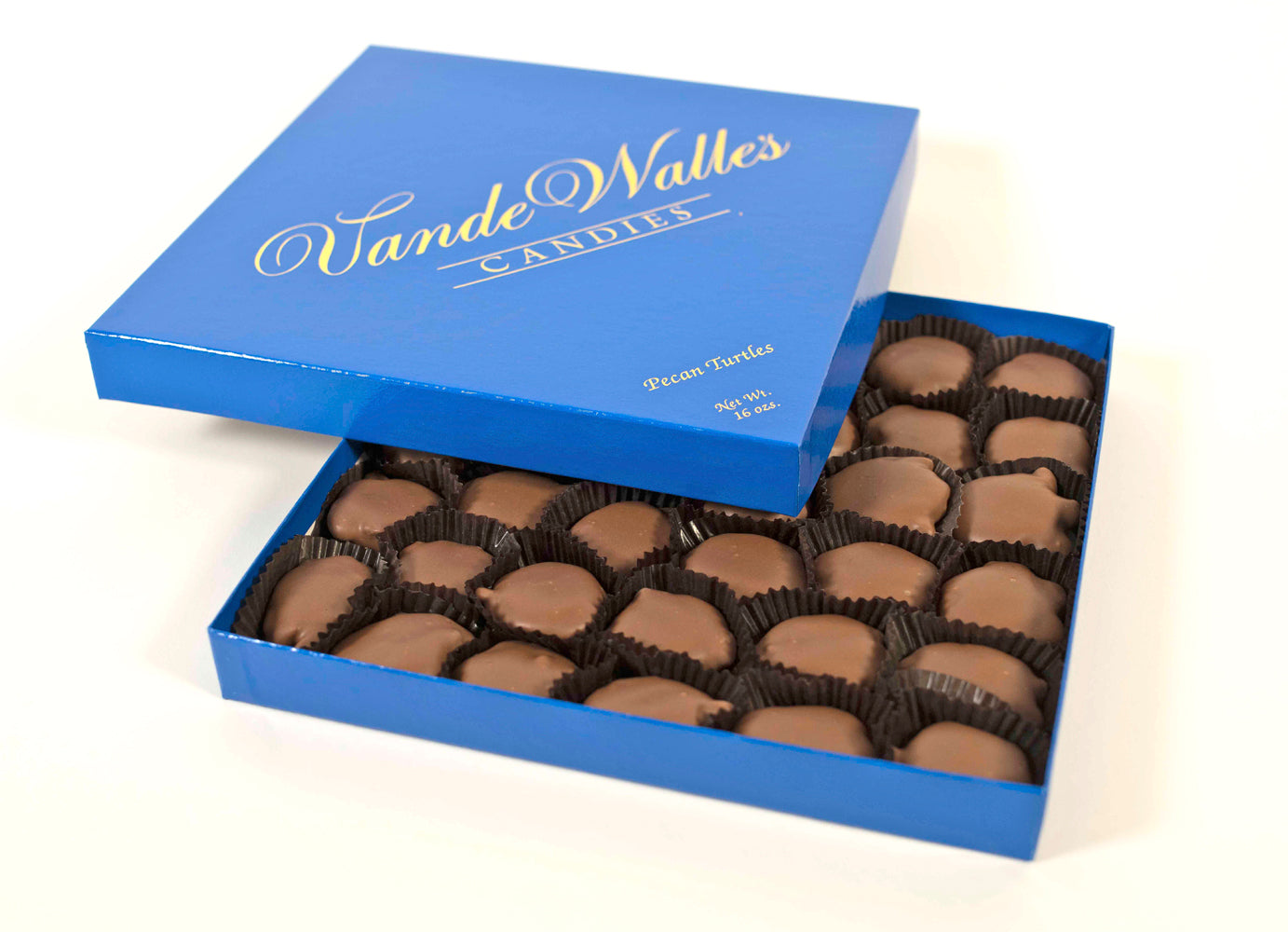 Open blue box of VandeWalle Candies  pecan turtles shown on a white background